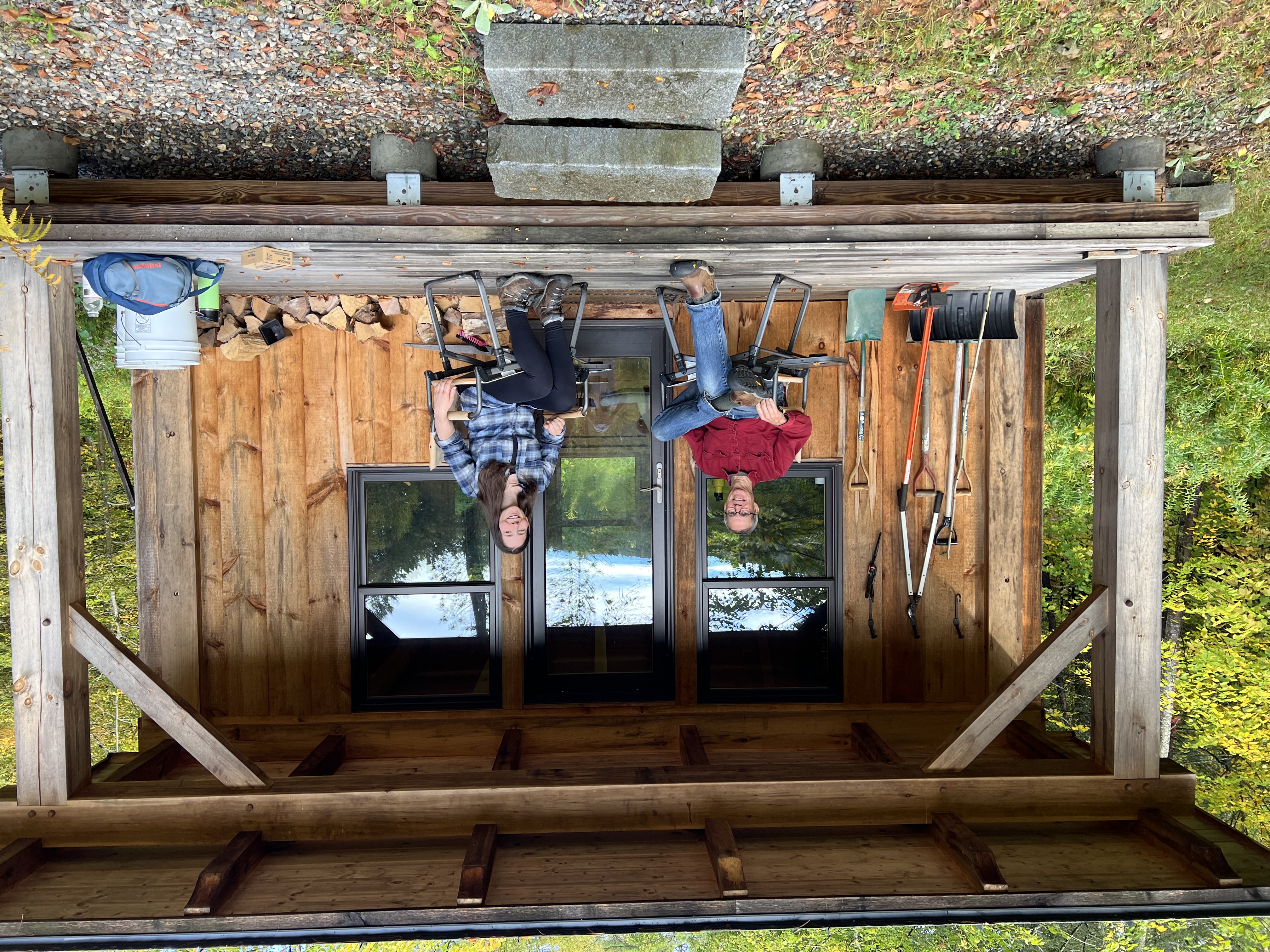 Alex and Florence sitting on the porch of a small cabin