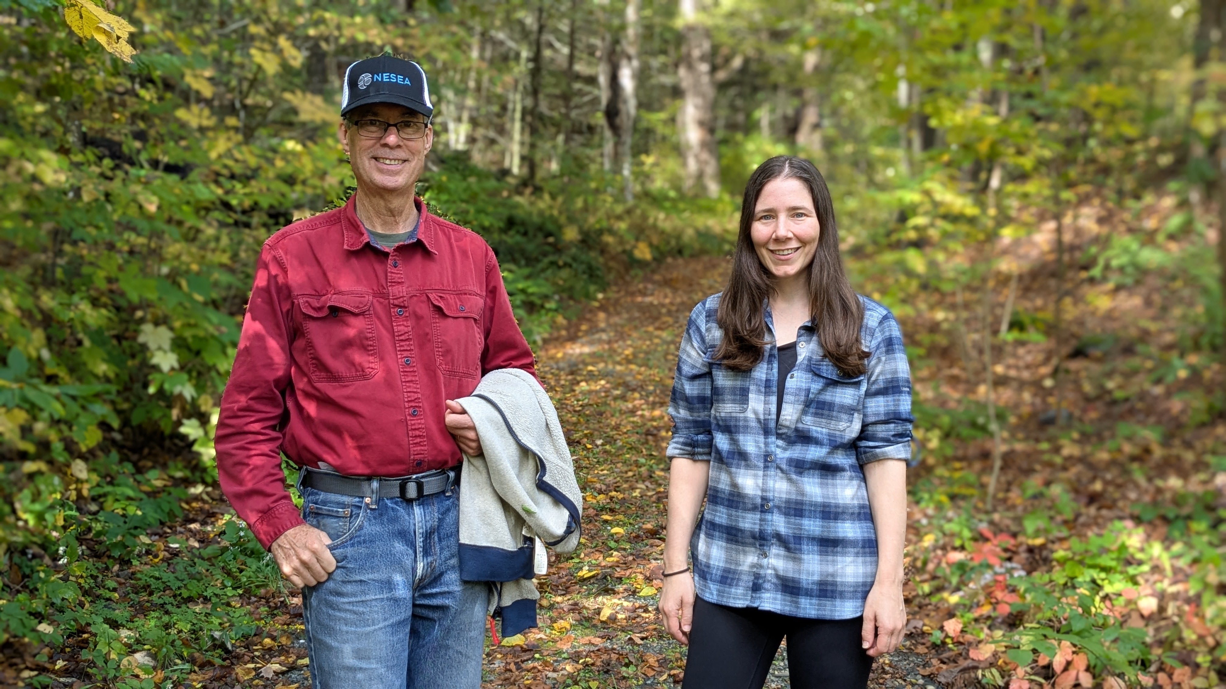 Florence and Alex smiling in the woods
