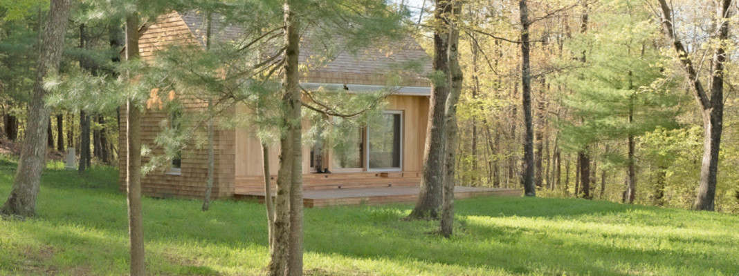 Small wood house nestled in some pine trees