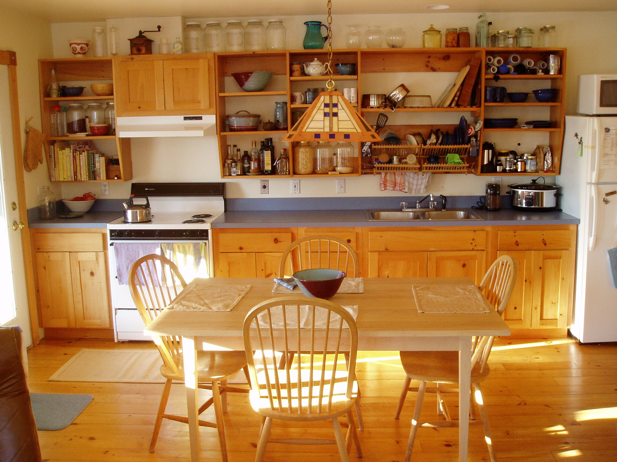Interior view of dining and kitchen showing bright compact home