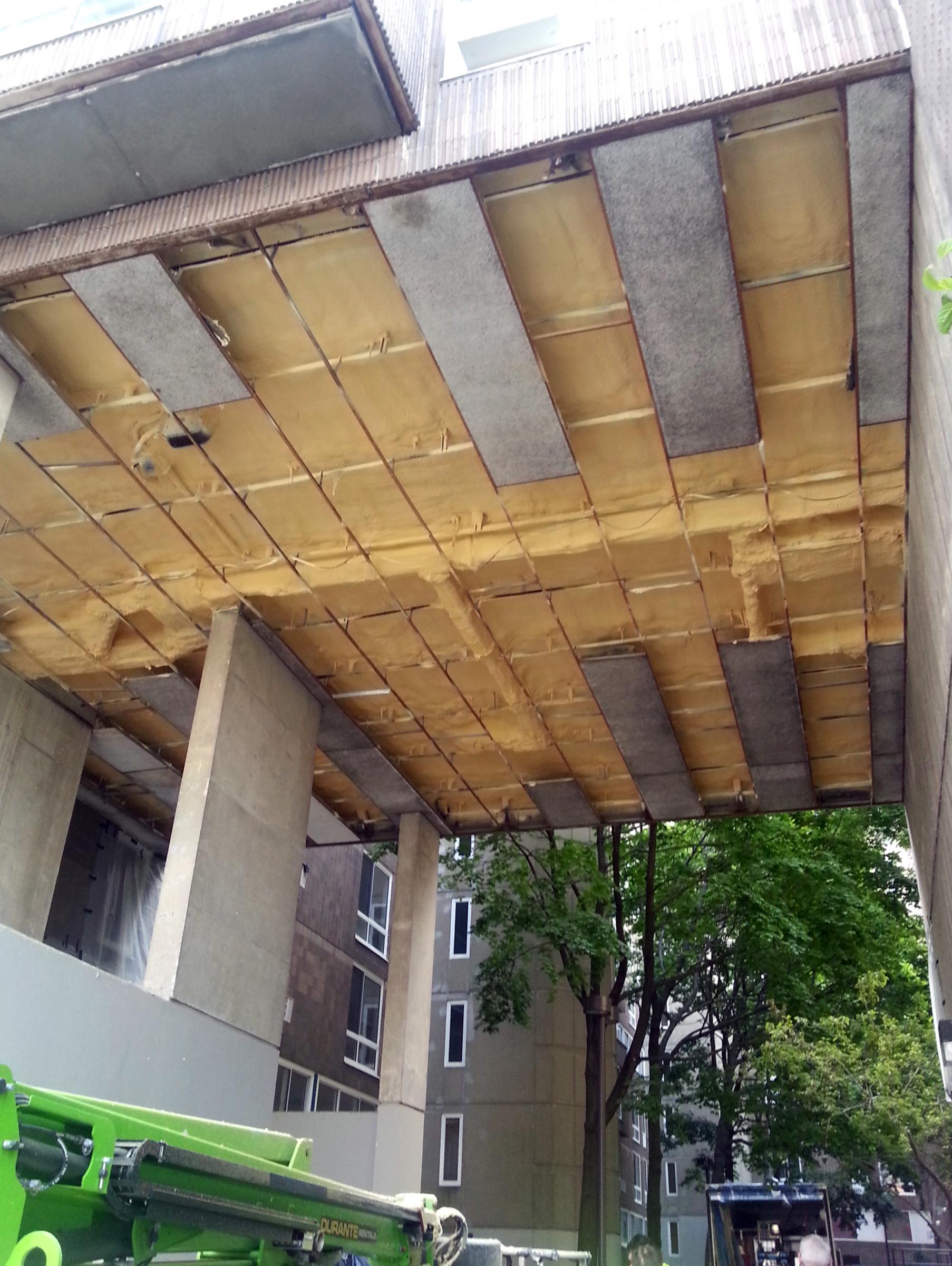 INSuLATIoN IS BEINg INSTALLED uNDER AN ExTERIoR FLooR AT RooSEvELT LANDINgS. ThE PhoTo WAS TAkEN oN JuNE 26, 2013.